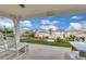 Inviting covered patio with comfortable seating and a view of the manicured backyard at 7639 Agrigento St, Clermont, FL 34714