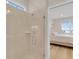 The bathroom has a glass shower enclosure and a view into a bedroom with a window at 7639 Agrigento St, Clermont, FL 34714