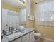 Bright bathroom with granite countertops, ample lighting, and fresh decor at 7660 Comrow St # 203, Kissimmee, FL 34747