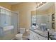 Well-lit bathroom featuring a glass shower, granite countertop, and modern fixtures at 7660 Comrow St # 203, Kissimmee, FL 34747