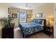 Comfortable bedroom with blue bedding, matching lamps, and a large window at 7660 Comrow St # 203, Kissimmee, FL 34747