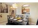 Dining area with place settings and an open view into the kitchen at 7660 Comrow St # 203, Kissimmee, FL 34747