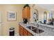 Kitchen featuring granite countertops, stainless steel sink, and wooden cabinets at 7660 Comrow St # 203, Kissimmee, FL 34747