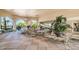 An outdoor lounge and seating area with potted plants, palm trees, and direct access to the community pool at 7660 Comrow St # 203, Kissimmee, FL 34747
