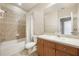 Well-lit bathroom featuring vanity with sink, toilet, and shower with tiled surround at 8168 Boat Hook Loop # 201/718, Windermere, FL 34786