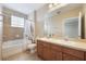 Bright bathroom featuring a double vanity, a tub and a shower at 8168 Boat Hook Loop # 201/718, Windermere, FL 34786