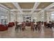 Clubhouse interior offers a lounge area with tables, chairs, and a TV at 8168 Boat Hook Loop # 201/718, Windermere, FL 34786