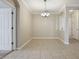 Neutral dining room with tile floors and contemporary chandelier fixture at 8168 Boat Hook Loop # 201/718, Windermere, FL 34786