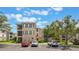 Exterior of a condominium complex with well-kept landscaping, reserved parking and community amenities at 8168 Boat Hook Loop # 201/718, Windermere, FL 34786