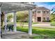 Exterior of a two-story home with a manicured lawn viewed from beneath a pergola at 8168 Boat Hook Loop # 201/718, Windermere, FL 34786