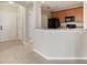 Cozy kitchen featuring granite countertops, wood cabinetry, and black appliances at 8168 Boat Hook Loop # 201/718, Windermere, FL 34786
