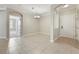 Open-concept living space featuring tile floors, arched doorways, and a modern chandelier at 8168 Boat Hook Loop # 201/718, Windermere, FL 34786