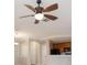 Close up of a modern ceiling fan, with kitchen and doorway archway in background at 8168 Boat Hook Loop # 201/718, Windermere, FL 34786