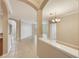 Spacious and open-concept living room with tile floors, neutral paint, and archway at 8168 Boat Hook Loop # 201/718, Windermere, FL 34786