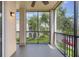 Screened patio with black railings offers views of the lawn and mature trees at 8168 Boat Hook Loop # 201/718, Windermere, FL 34786