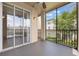 View of screened patio with sliding glass doors and a ceiling fan offers exterior views at 8168 Boat Hook Loop # 201/718, Windermere, FL 34786