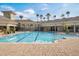A stunning community pool with palm trees and ample lounging space at 8168 Boat Hook Loop # 201/718, Windermere, FL 34786