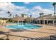 Beautiful community pool, surrounded by palm trees and comfortable seating at 8168 Boat Hook Loop # 201/718, Windermere, FL 34786