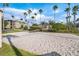Sand volleyball court with net, gazebo, and palm trees in a well-maintained community setting for outdoor recreation at 8168 Boat Hook Loop # 201/718, Windermere, FL 34786