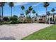 Sand volleyball court with palm trees in a well-maintained community setting, perfect for outdoor recreation at 8168 Boat Hook Loop # 201/718, Windermere, FL 34786