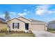 Charming single-story home with a well-manicured lawn, inviting entry and two car garage at 865 Citrus Reserve Blvd, Davenport, FL 33837