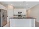 Well-lit kitchen featuring a center island, stainless steel appliances, and white cabinets at 865 Citrus Reserve Blvd, Davenport, FL 33837