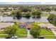 Aerial view of a waterfront home in a residential neighborhood with lush greenery and scenic views at 930 Chickadee Dr, Port Orange, FL 32127