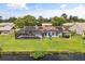 An aerial view of the backyard features a pool, playset, picnic area, and water access at 930 Chickadee Dr, Port Orange, FL 32127