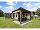 A large backyard features a picnic area and a playset, creating a great area for Gathering activities at 930 Chickadee Dr, Port Orange, FL 32127