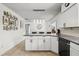 Kitchen island with granite countertop and white cabinetry, open to dining area at 930 Chickadee Dr, Port Orange, FL 32127