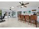 Open living area featuring a bar, tile flooring, and access to the outdoor spaces at 930 Chickadee Dr, Port Orange, FL 32127