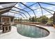 The screened-in pool features an outside view of the water and a built-in seating area at 930 Chickadee Dr, Port Orange, FL 32127