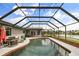 The screened-in pool features a covered seating area and is an ideal spot for entertaining guests at 930 Chickadee Dr, Port Orange, FL 32127
