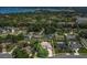 Aerial view highlights the home’s location in a beautiful, tree-lined neighborhood and its proximity to the park at 9319 Woodbreeze Blvd, Windermere, FL 34786
