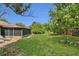 Lush backyard with a spacious lawn, perfect for relaxation or outdoor activities, and an enclosed patio at 9319 Woodbreeze Blvd, Windermere, FL 34786