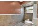Neutral bathroom with shower/tub combination, tiled walls, and modern toilet at 9319 Woodbreeze Blvd, Windermere, FL 34786