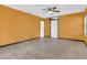 Spacious bedroom with neutral tile flooring, ceiling fan, and adjacent doors at 9319 Woodbreeze Blvd, Windermere, FL 34786