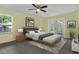 Cozy main bedroom featuring soft colors, a ceiling fan, a window, and access to the outdoors at 9319 Woodbreeze Blvd, Windermere, FL 34786