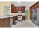 Traditional kitchen with stainless appliances, wood cabinets, and a breakfast bar at 9319 Woodbreeze Blvd, Windermere, FL 34786