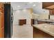 Kitchen features granite countertops, stainless steel appliances, wood cabinets, and tile floors at 9319 Woodbreeze Blvd, Windermere, FL 34786