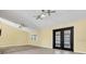 Open living area with vaulted ceilings, tile flooring, and black french doors at 9319 Woodbreeze Blvd, Windermere, FL 34786