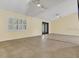 Spacious living area with vaulted ceilings, tile flooring, and ample natural light at 9319 Woodbreeze Blvd, Windermere, FL 34786