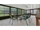Bright sun room enclosed with glass panels featuring tile floors and patio furniture at 9319 Woodbreeze Blvd, Windermere, FL 34786