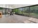 Bright sun room enclosed with glass panels featuring tile floors and patio furniture at 9319 Woodbreeze Blvd, Windermere, FL 34786