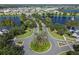 Aerial view of the community with winding roads, lush landscaping, and nearby lake at 934 Rock Harbor Ave, Orlando, FL 32828