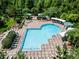An aerial view showcases the pool with lounge chairs, shade structures, and lush landscaping at 934 Rock Harbor Ave, Orlando, FL 32828