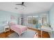 Comfortable bedroom featuring a bed, desk, bookshelf, and a window with a lot of natural light at 934 Rock Harbor Ave, Orlando, FL 32828