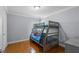 Bedroom featuring bunk beds, hardwood floors, and a window with a lot of natural light at 934 Rock Harbor Ave, Orlando, FL 32828