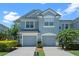 Charming two-story townhouse with attached garages, lush landscaping, and beautiful curb appeal at 934 Rock Harbor Ave, Orlando, FL 32828