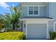 Attached garage of a charming home with lush landscaping with a beautifully maintained exterior at 934 Rock Harbor Ave, Orlando, FL 32828